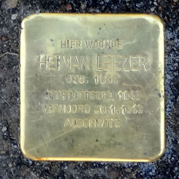 Ein rechteckiges Messingschild am Boden mit der Inschrift "Hier Woonde Heiman Leezer", das einen deutschen Soldaten ehrt, der im Zweiten Weltkrieg starb.